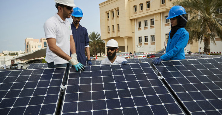 engineers outside with solar panels