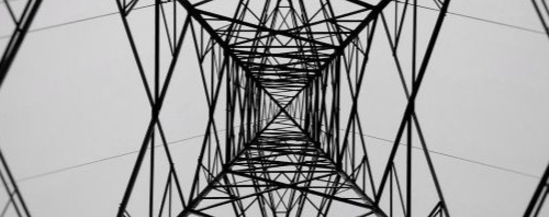 Electricity pylon viewed from below. Black and white image. 