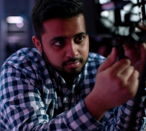 Male broadcast engineer works in studio