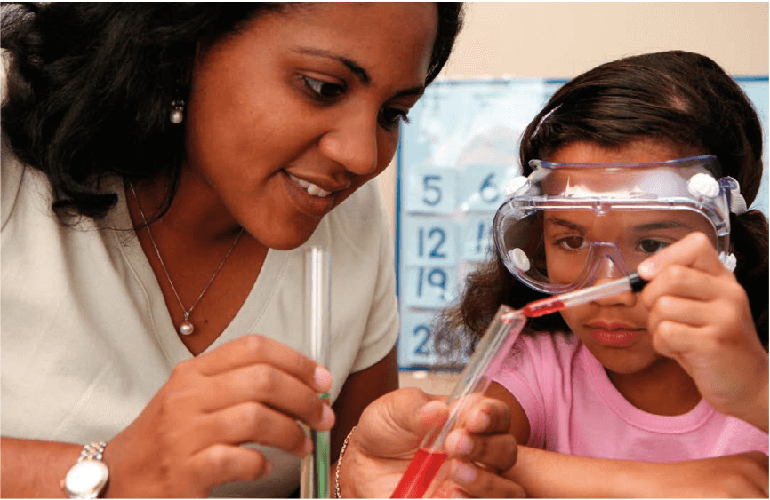 An adult and a child doing science experiments by pipetting liquid into a test tube.