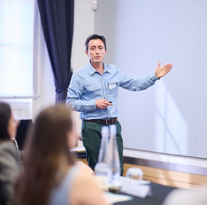 LIF Global 2025 awardee stands presenting from the front.